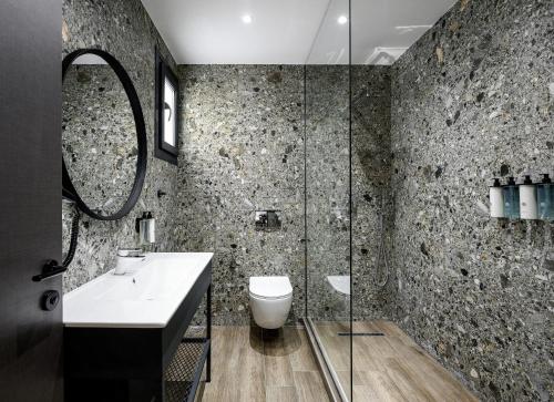 a bathroom with a toilet and a sink and a shower at Pillow urban stay in Thessaloniki