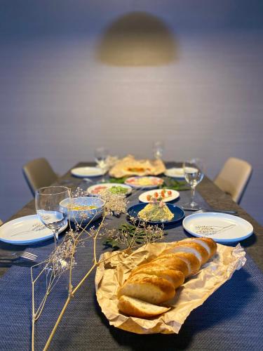 a table with plates of food and wine glasses at Randor Hotel Sapporo Suites in Sapporo