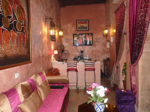 a living room with a couch and a bar at Riad Marlinea in Sale