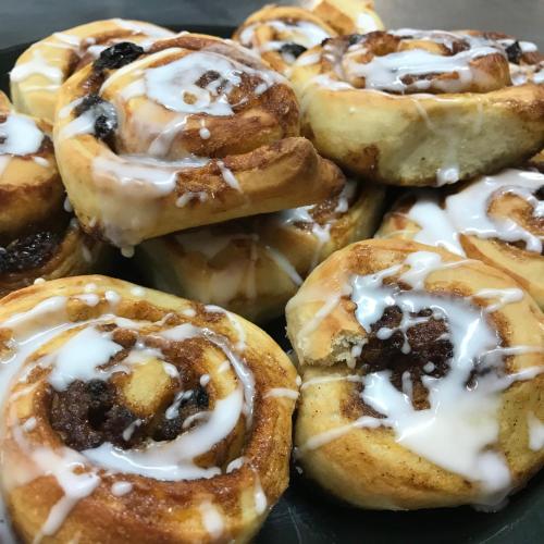 a group of donuts with icing on a plate at Ty Mawr Country Hotel & Restaurant in Carmarthen