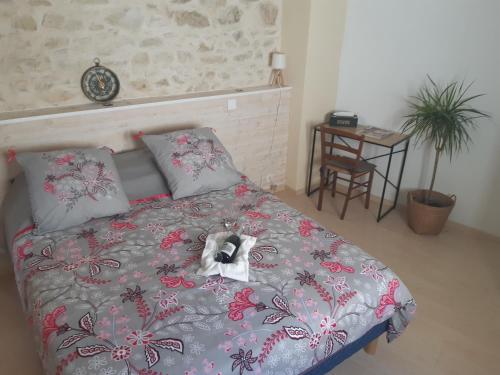 a bedroom with a bed with a bow on it at Suite Privée Bed and Breakfast in Nîmes