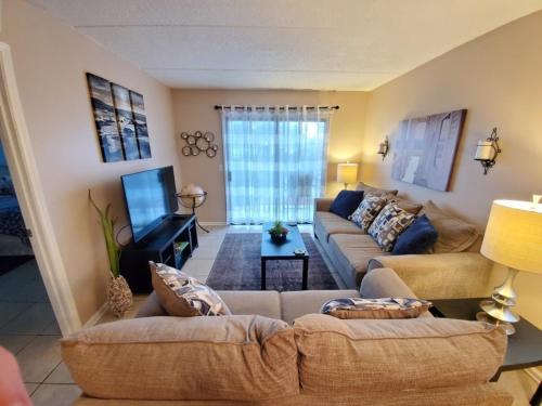 a living room with two couches and a tv at St, Augustine Ocean And Racquet 2204 Condo in Saint Augustine