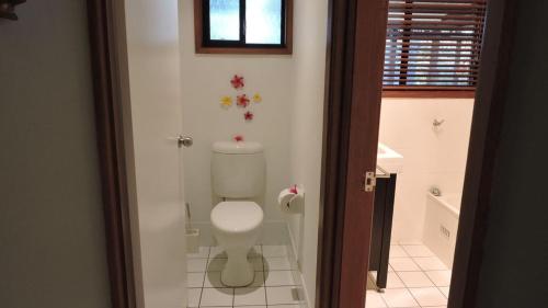 a bathroom with a white toilet in a room at Waterfront Jervis Bay Escape Cooinda in Sanctuary Point