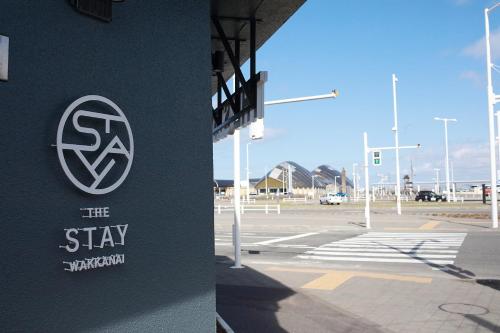 a sign on the side of a building next to a parking lot at THE STAY WAKKANAI in Wakkanai
