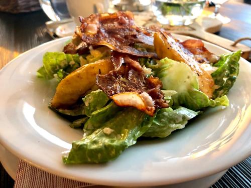 a plate of food with a salad on a table at Hotel McLimon in Nový Jičín