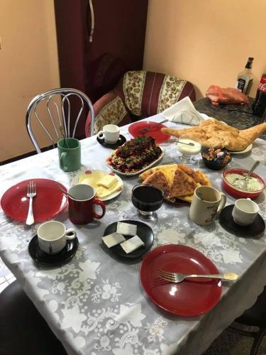 a table with plates and cups and food on it at DEA in Zugdidi