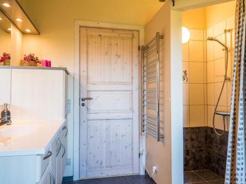 a bathroom with a shower and a door at Tranquil Cottage with Spa and Sauna-By Traum in Hemmet