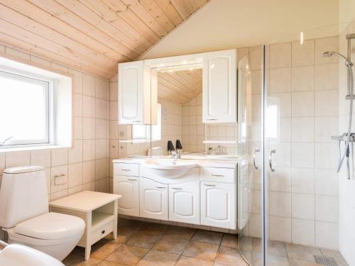 a bathroom with a toilet and a sink and a shower at 6 person holiday home in Tarm in Tarm