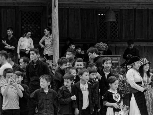 a black and white photo of a crowd of children at Meo Vac Cosy Hostel in Mèo Vạc