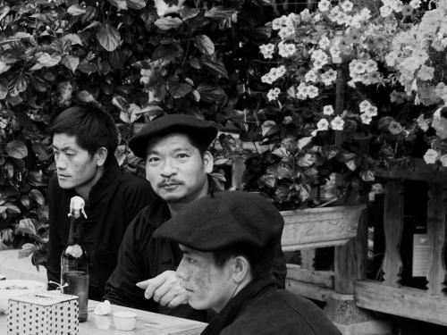a group of men sitting at a table at Meo Vac Cosy Hostel in Mèo Vạc