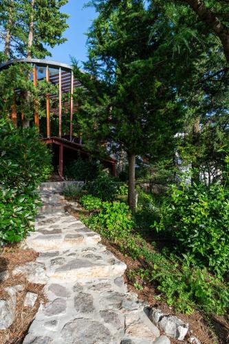 a stone path leading to a house with a bridge at Mitan Accommodation in Novi Vinodolski