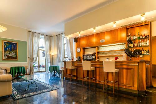 a bar with white chairs in a room at Hotel San Donato - Bologna centro in Bologna
