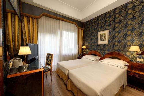 a hotel room with a bed and a television at Best Western Hotel Rivoli in Rome