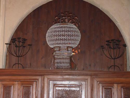 a chandelier hanging over a wooden door at Riad Marlinea in Sale