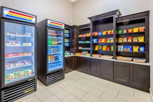 a store aisle with a refrigerator and some food at La Quinta by Wyndham Gainesville in Gainesville