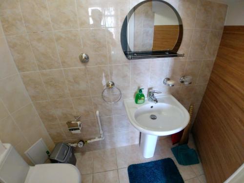 a bathroom with a sink and a toilet and a mirror at Котеджі на приватному пляжу - Совіньйон 2025 in Odesa
