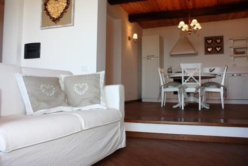 a living room with a white couch and a table at La Codarda country house in Pescosolido