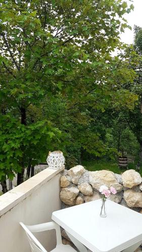 a white table with a vase on it next to some rocks at Villa Rico Masseria nel Parco in Caramanico Terme