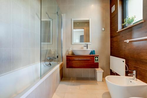 a bathroom with a sink and a tub and a sink at One Bedroom Apartment in Albur Village 2J in Alvor