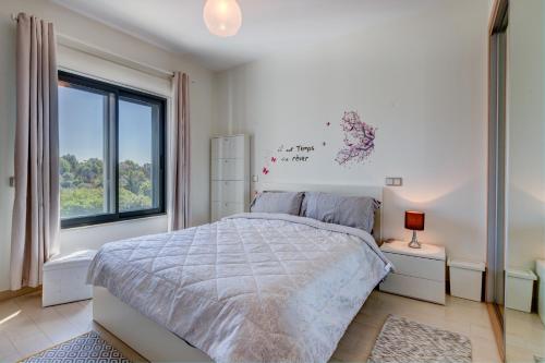a bedroom with a large bed and a window at One Bedroom Apartment in Albur Village 2J in Alvor