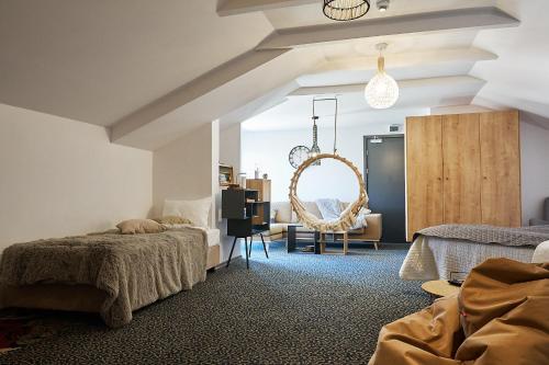 a bedroom with two beds and a chair at Armada Apart Ustka in Ustka