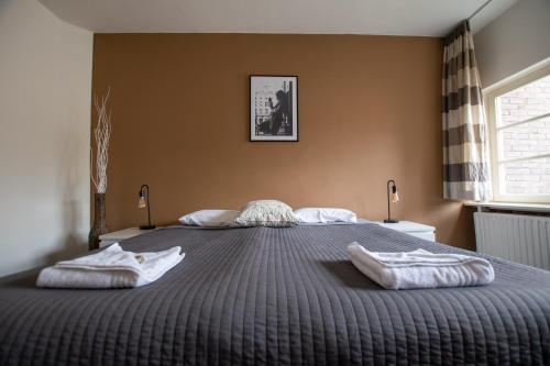 Кровать или кровати в номере B&B De Hofnar Maastricht