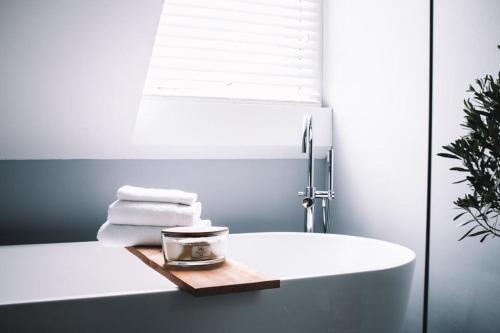 a bathroom with a white tub and a sink at B&B Logeren bij Lies in Harderwijk