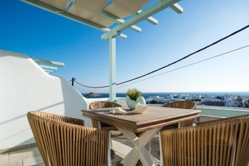 a table and chairs on a balcony with a view at Villa Meliti in Platis Yialos Mykonos