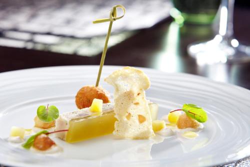 a white plate with food on a table at Langshott Manor - Luxury Hotel Gatwick in Horley