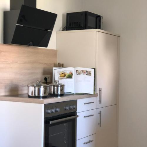 a kitchen with pots and pans on a stove at Ferienwohnung Kleine Auszeit in Maring-Noviand