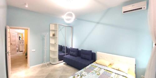 a blue room with a bed and a mirror at Berta Maria in Odesa
