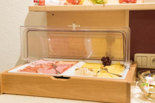 a wooden box filled with different types of food at Aparthotel Acksteiner in Sankt Anton am Arlberg