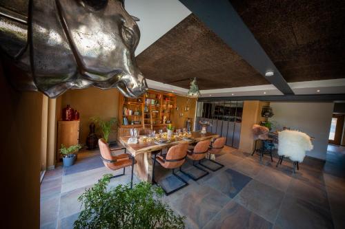 a dining room with a wooden table and chairs at Green & Breakfast in Niederpallen
