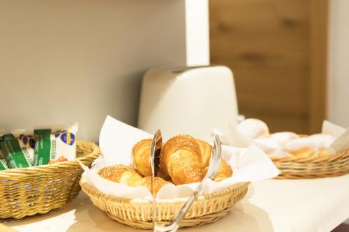 two baskets of bread sitting on a table with bread at Aparthotel Acksteiner in Sankt Anton am Arlberg