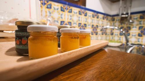 four jars of honey on a wooden tray in a kitchen at Casa di Marina-Trevi in Trevi nel Lazio