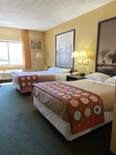 a hotel room with two beds and a large window at Super 8 by Wyndham Port Clinton in Port Clinton