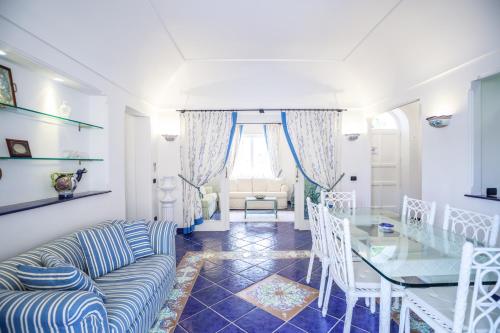 a living room with a couch and a glass table at Villino Dei Gerani in Capri