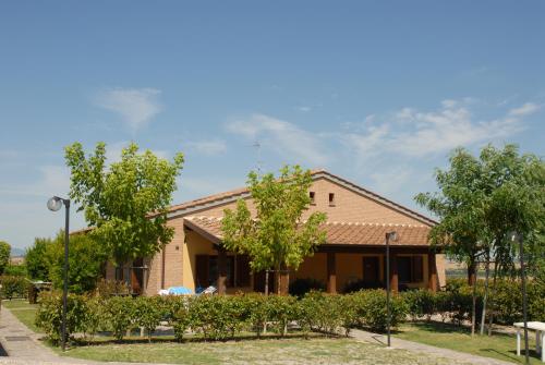 a building with a bunch of trees in front of it at Agriturismo Tenuta Badia in Paciano