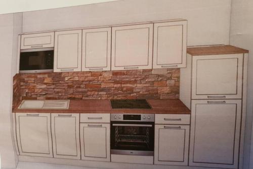 a kitchen with white cabinets and a brick wall at Oberland-Ferienwohnung inkl Königscard bis zu 150 Attraktionen inkl in Unterammergau