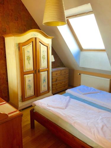 a bedroom with a large bed with a skylight at Palasta Premium in Rīga