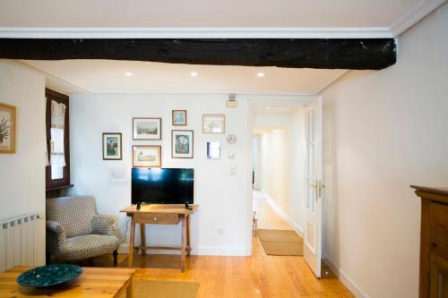 a living room with a television and a table at Txoriak - Basquenjoy in Hondarribia