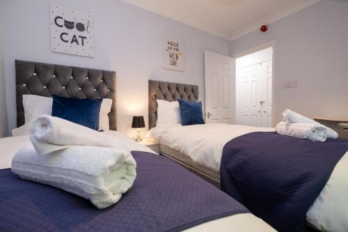 a bedroom with two beds with blue and white at Brunswick in Brighton and Hove by 9S Living in Brighton & Hove