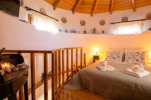 a bedroom with a bed with two towels on it at Traditional Windmill-Milos in Kroústas