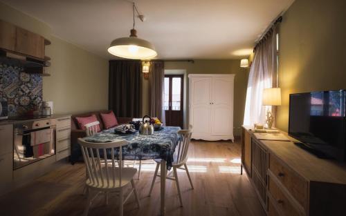 a kitchen with a table and chairs in a room at La Maison Du Lac Iseo in Predore