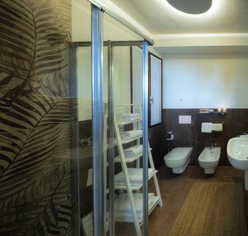 a bathroom with a shower and a toilet and a sink at La Maison Du Lac Iseo in Predore