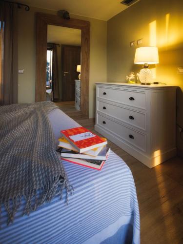 a bedroom with a bed with a dresser and a lamp at La Maison Du Lac Iseo in Predore