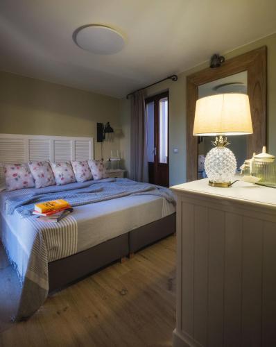 a bedroom with a bed and a table with a lamp at La Maison Du Lac Iseo in Predore