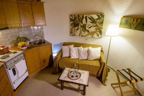 a small room with a bed and a kitchen at Traditional Windmill-Milos in Kroústas