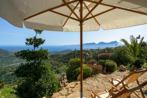 an umbrella sitting on top of a table at Traditional Windmill-Milos in Kroústas