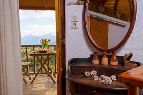 a room with a mirror and a table with vases at Traditional Windmill-Milos in Kroústas